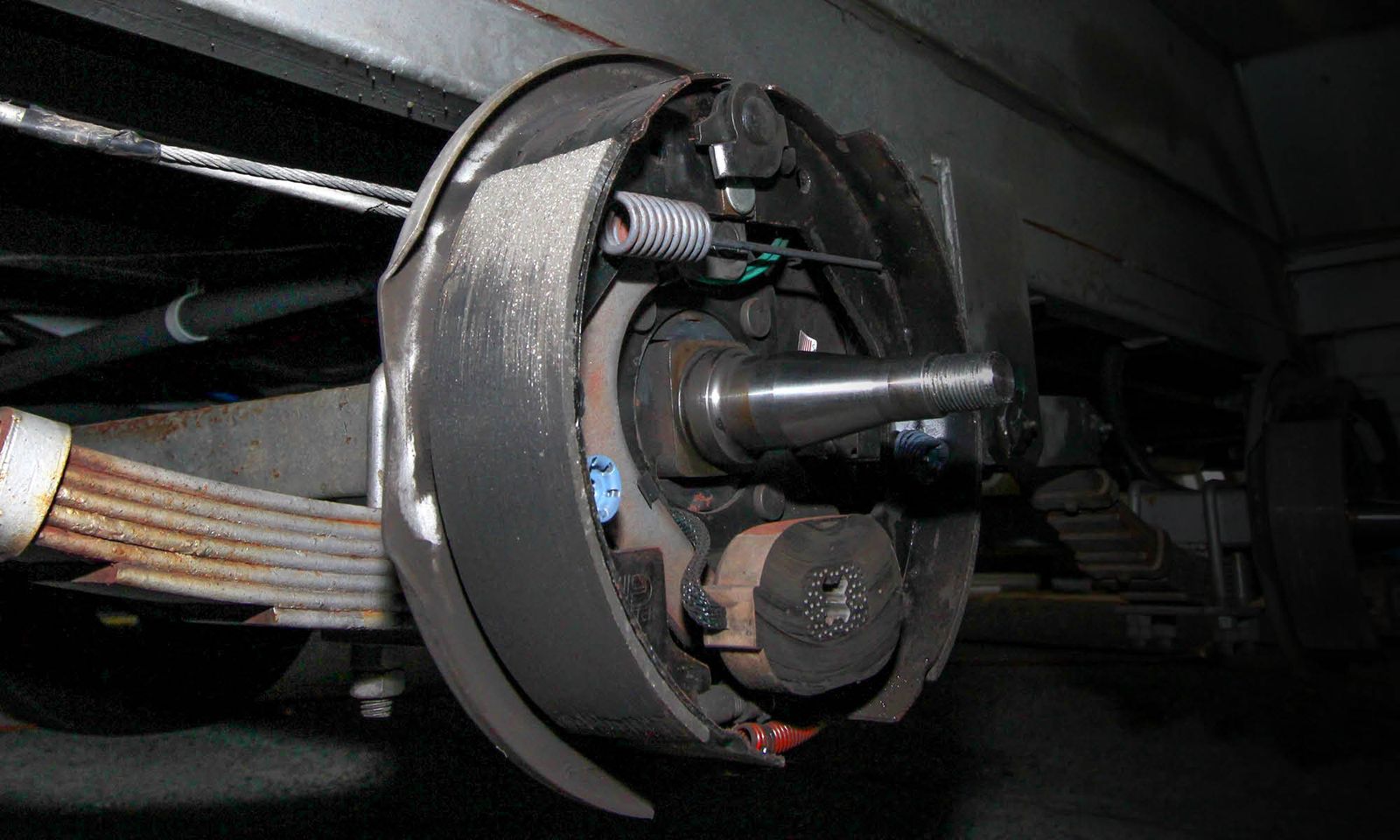 Caravan brake drum removed, showing the brake shoes, magnet and bearing stub axle