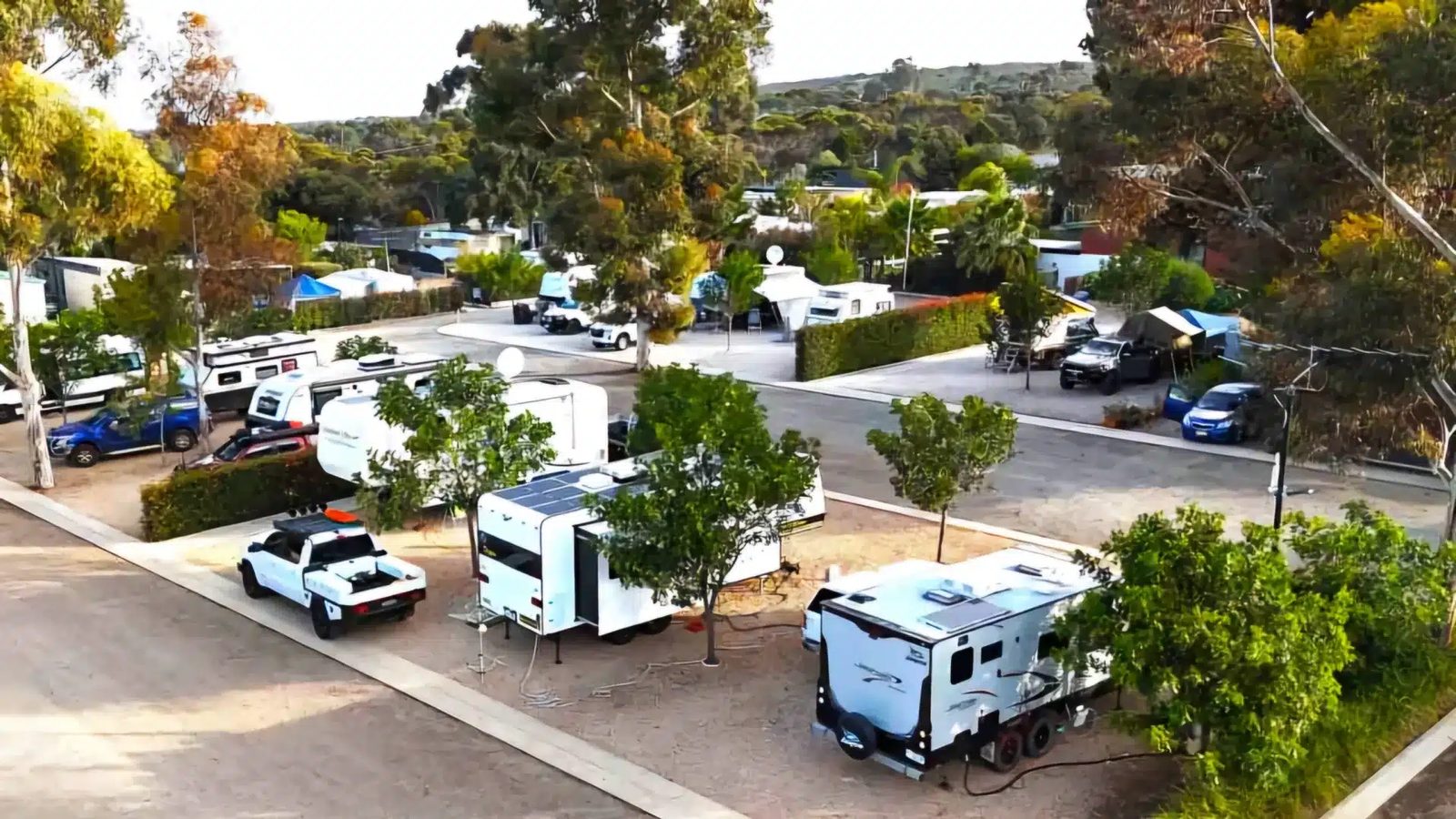 Caravans with rooftop solar set up on riverside sites at a Murray Bridge caravan park
