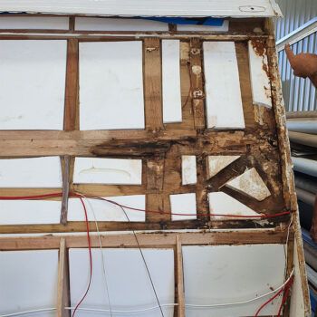 Rotted timber frame inside a caravan wall after long-term water entry