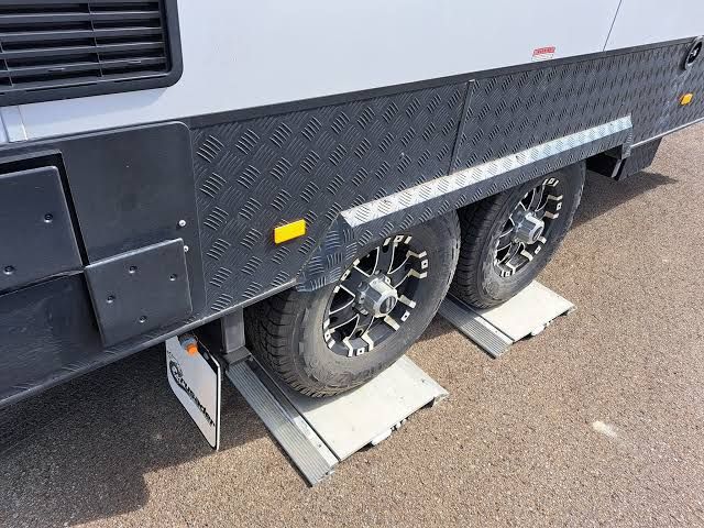 A tandem-axle caravan on portable weigh pads